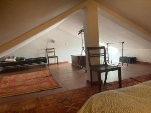 a bedroom with a bed and a chair and a table at Cozy Country House near Beaches in Azoia