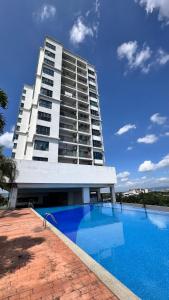 a building with a swimming pool in front of a building at LurVestay in Shah Alam