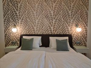 a bedroom with a bed with two lights on it at Penzion PIANO & Apartment Sokolov in Sokolov