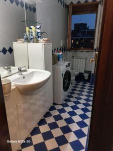 a bathroom with a sink and a washing machine at # Punto FM 9 # in Marghera