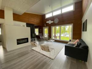 a living room with a couch and a fireplace at Villa beach star in Ranua