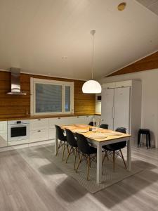 a kitchen with a dining room table and chairs at Villa beach star in Ranua +25 photos