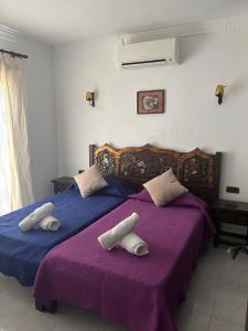 Ein Bett oder Betten in einem Zimmer der Unterkunft Villa Puerto Blanco