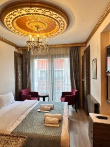 a bedroom with a large bed and a chandelier at taksim white family suites in Istanbul