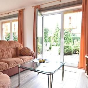 a living room with a couch and a glass table at Ferienwohnung Klast F51 in Kühlungsborn +7 photos