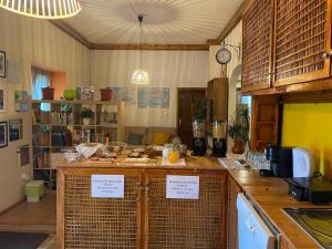 a kitchen with a counter with signs on it at Casa da Abrunheira in Ramalhal