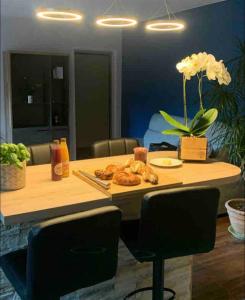 a table with a plate of croissants on it at Chez Mathias 2 bedrooms 2 beds cribs garage in Kaysersberg