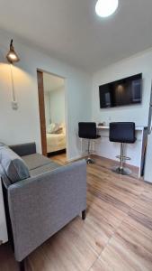 a living room with a couch and two chairs at Beautiful Independent House in Punta Arenas