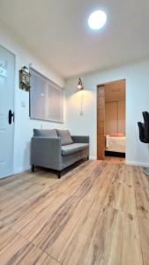 a living room with a couch and a bed at Beautiful Independent House in Punta Arenas +2 photos