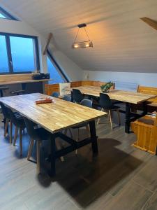 a dining room with wooden tables and chairs at Lysgaardcottage 360 sauna spa bar Dancing 25V in La Bresse +63 photos