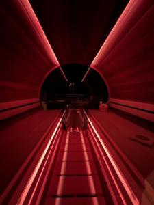 an escalator in a red tunnel with red lights at Matteo Villa Limassol Cyprus in Limassol