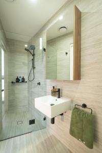 a bathroom with a white sink and a shower at Executive Rental - Campbelltown in Campbelltown +23 photos
