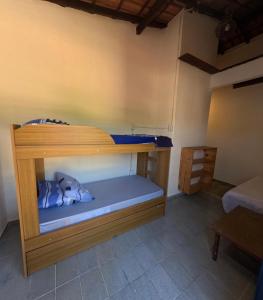 a bunk bed in a room with a blue mattress at Guaecá Hostel - Cumuruxatiba in Cumuruxatiba