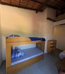 a bunk bed in a room with a blue mattress at Guaecá Hostel - Cumuruxatiba in Cumuruxatiba