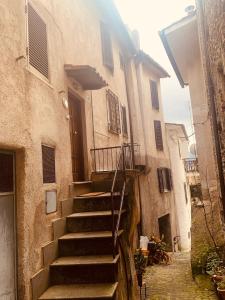a set of stairs leading to a building with a door at La Casa di Vale in Marano Equo