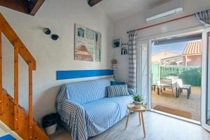 a living room with a couch and a sliding glass door at La Casa Di Benedetta in Portiragnes