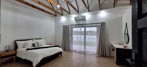 a bedroom with a bed and a large window at Golden Treasure - OFF GRID in eMalahleni