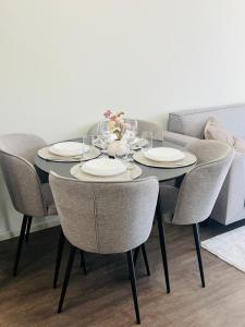 a dining room table with chairs and plates on it at IN&P Apartment - top location in Veliko Tŭrnovo