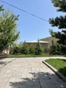 an empty parking lot with trees and a building at Dream House in Tsaghkadzor