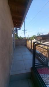 a balcony of a building with a fence at JeiDanApart alojamiento in Puerto Iguazú