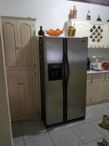 a stainless steel refrigerator in a kitchen at Diana place in Spanish Town