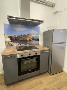 a kitchen with a sink and a refrigerator at Matilde House a Genova, Boccadasse, appartamento completo ed esclusivo in Genova