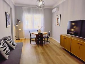 a living room with a table and a tv at Civico 34 Urban House in Ciampino