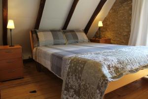a bedroom with a bed and two night stands at Gites le Sud, La Petite Grange in Puybrun