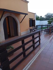 a balcony with a fireplace on the side of a building at Casal Mastro appartamenti e camere con piscina in Bisceglie