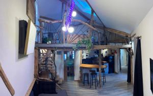 a room with a staircase and a table and chairs at La cabane a Joseph in Tarascon-sur-Ariège