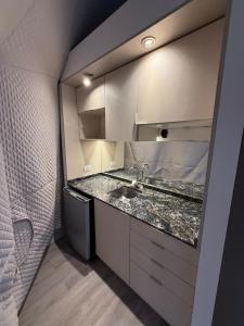 a bathroom with a sink and a mirror at Los Cardos Lodge & Glamping in Malargüe