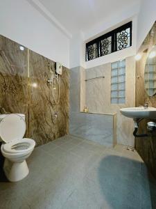 a bathroom with a toilet and a sink at 17C đặng văn ngữ 102 in Ho Chi Minh City