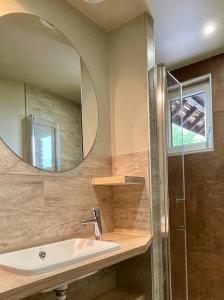 a bathroom with a sink and a mirror at Les Cottages d'Orient Gite Boutique in Mesnil-Saint-Père +36 photos