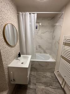 a white bathroom with a sink and a mirror at La Căsă in Vulcan