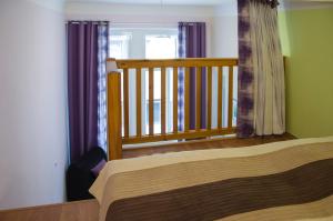 a bedroom with a wooden bed and a balcony at Apartment Jindrisska 25 in Prague