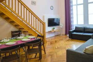 a living room with a table with chairs and a couch at Apartment Jindrisska 25 in Prague