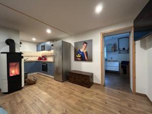 a living room with a fireplace and a kitchen at Ferienhaus Emma Dresden Hellerau in Dresden +12 photos