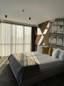 a bedroom with a large bed with a large window at MM Boutique Hotel in Burgas +37 photos