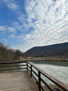a wooden bridge over a body of water at Samshvilde Hideaway in Daghetʼkhachʼini