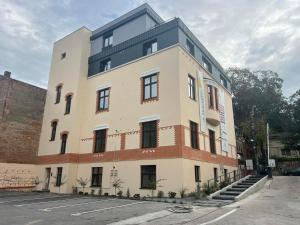 a large white building with a lot of windows at Ophir Apartment Central in Cluj-Napoca