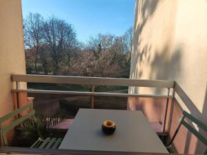 a vase sitting on top of a table on a balcony at T3 COSY petit balcon 5mins France miniature in Élancourt