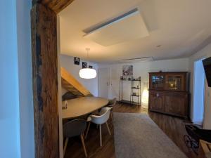 a dining room with a table and some chairs at fewoflagmeier Meidelstetten I Maisonetten Wohnung Alb in Hohenstein