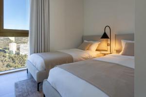 Postel nebo postele na pokoji v ubytování Intempo E3 Apartment + 40 fotografií