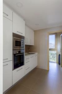 Kuchyň nebo kuchyňský kout v ubytování Intempo E3 Apartment
