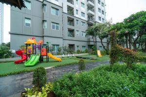 a playground in front of a apartment building at Charming and lovely 1BR Near GI Mall Thamrin, SCBD2 in Jakarta
