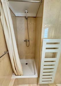 a bathroom with a shower with a shower curtain at Cosy Cocoon Place Massena in Nice