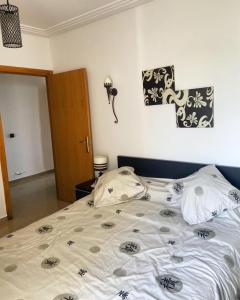 a bedroom with a large bed with at Golf & sea view appartement in Asilah Marina Golf in Asilah