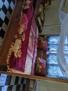 a shelf with blankets and other items on it at Kanani Home Stay in Lushoto +1 photo