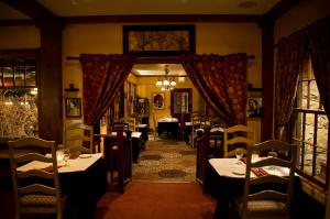 a restaurant with tables and chairs in a room at Glen Tavern Inn in Santa Paula