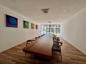 a long room with a long table and chairs at Gala City CornerApt Gala residence in Kuching +23 photos